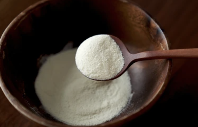 Skim milk powder in a wooden bowl